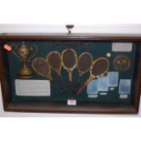 A reproduction framed and glazed display of the history of the tennis racquet