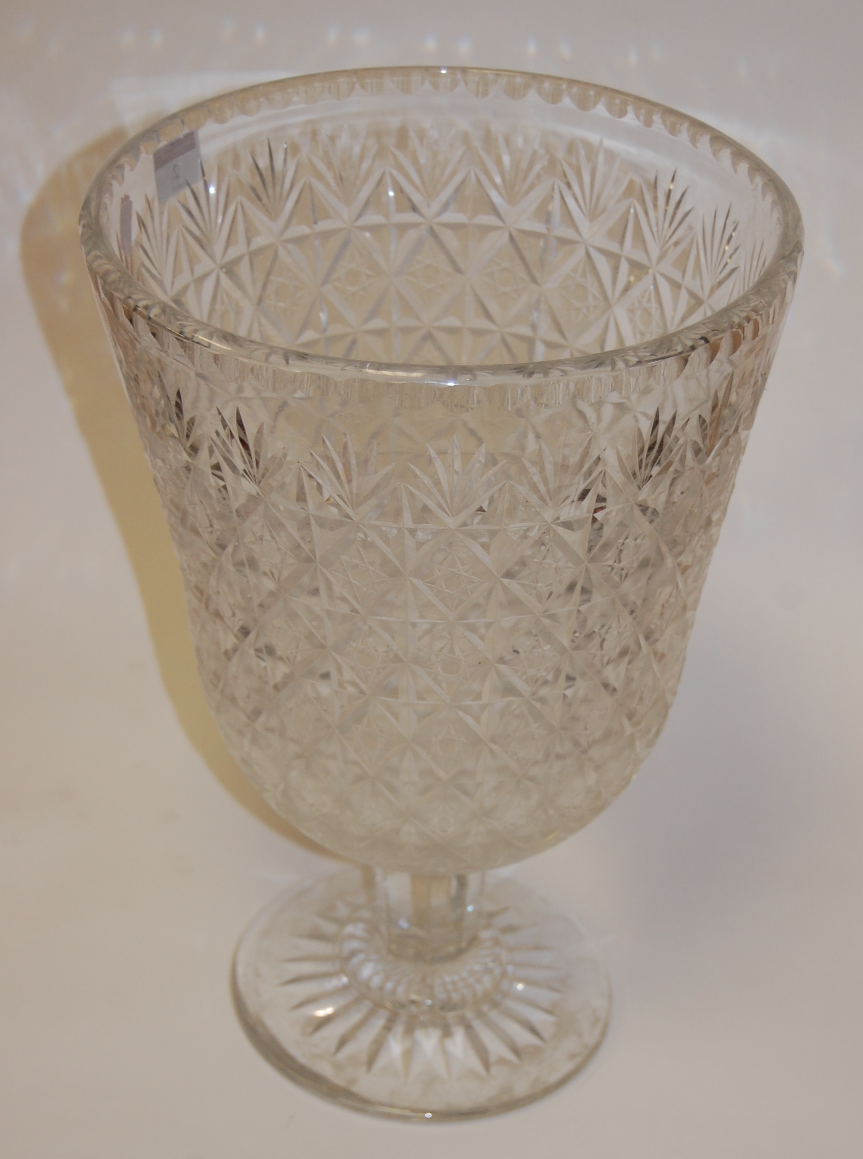 An extremely large cut glass pedestal bowl, on star-cut base (chip to footrim), h.