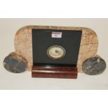 An Art Deco veined marble cased mantel clock having silvered engine turned dial with Arabic