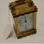 A lacquered brass case carriage clock with alarm having unsigned white enamel dial,