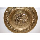 A 20th century brass charger depicting a tavern scene