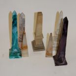 A small collection of assorted obelisk desk ornaments to include slag glass examples