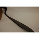 A large early 20th century iron grain scythe having a turned pine handle