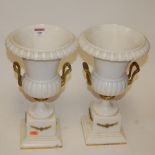 A pair of faux marble table lamps each in the form of a campagna shaped urn with gilt metal mounts