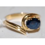 A modern 18ct gold and sapphire dress ring,