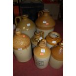 Seven various stoneware jars to include; GG Gross Wine & Spirit Merchants, Four Swans Sudbury,