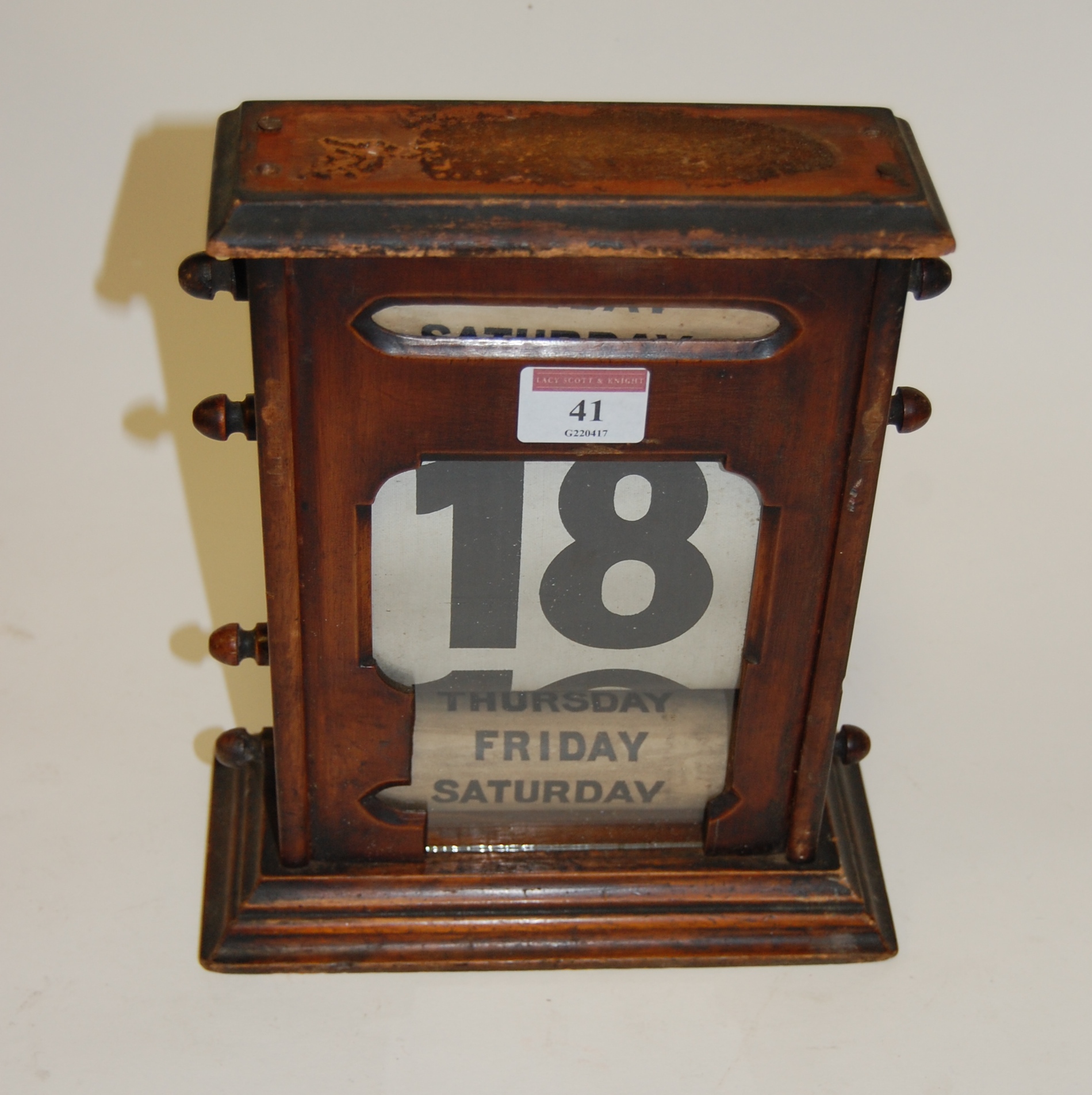 An early 20th century mahogany cased perpetual calendar having rolling day date apertures