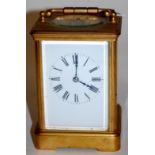 A circa 1900 French lacquered brass carriage clock having white enamel dial,