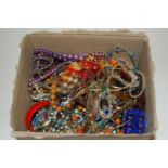 A box of assorted costume jewellery to included beaded necklaces