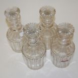 A set of four cut crystal glass decanters and stoppers