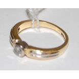 An 18ct gold diamond solitaire ring, the illusion set brilliant weighing approx 0.
