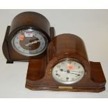 An Art Deco walnut cased mantel clock having a silvered dial with Arabic numerals,