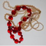 Three faux pearl necklaces and a beaded ruby glass necklace (4)
