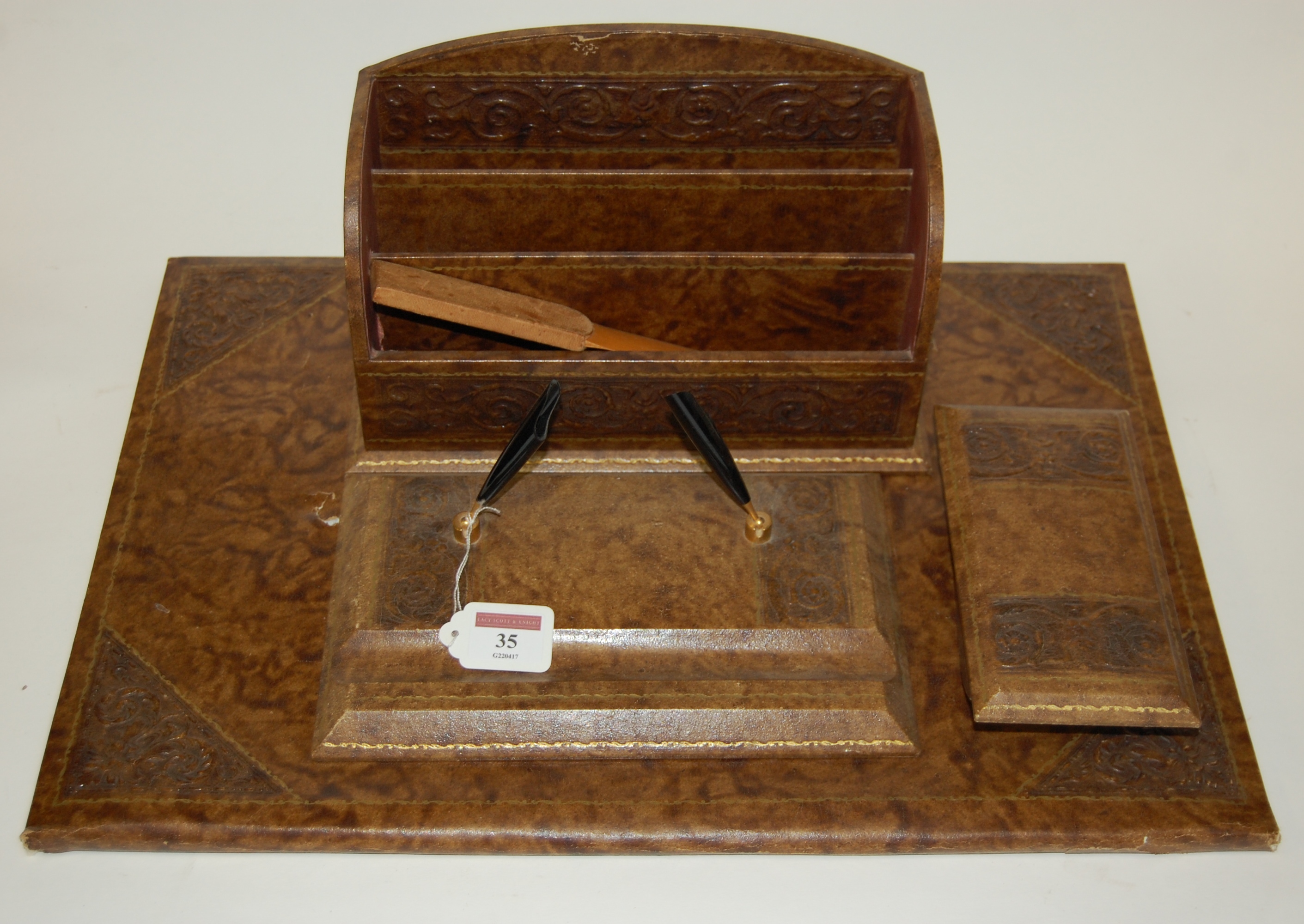 A Victorian style leather clad desk set to include stationery rack,