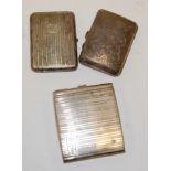 An engine turned silver pocket cigarette case and two others, gross weight 9.