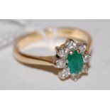 An 18ct gold emerald and diamond flower head cluster ring,