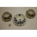 A pair of Herend porcelain teacups and saucers, each hand-painted with floral sprays,