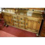 A moulded oak sideboard,