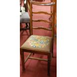 A set of three Edwardian walnut ladderback dining chairs;