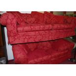 A pair of good quality modern red floral upholstered three seater sofas, the larger w.