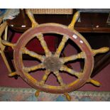A painted and metal bound ships wheel