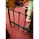 A Victorian style black painted wrought iron and brass double bedstead,