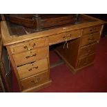 A Victorian pine round cornered and red leather gilt tooled inset kneehole writing desk,