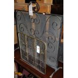 A black painted wrought iron sparkguard;