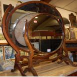 An early 20th century mahogany oval swing dressing table mirror;