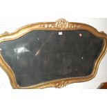A giltwood framed wall mirror, of shaped form, w.