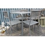 A modern metal patio set comprising small square table and four stacking chairs