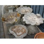 A set of three reconstituted stoneware pedestal shell bird baths,