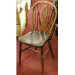 A pair of early 20th century elmseat and beech wheelback kitchen chairs;