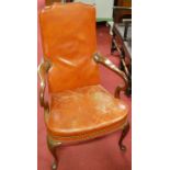 A mahogany framed, tan leather upholstered and studded Gainsborough chair,