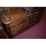 A provincial French joined oak sideboard, having shaped top and fitted with six drawers, w.