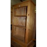 A small modern pine freestanding open bookshelf;