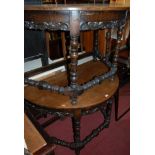 A pair of Continental oak demi-lune side tables, each with carved lower floral frieze,