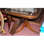 ***NO STOOL IN THIS LOT*** A reproduction mahogany twin pillar dining table, in the Regency taste,