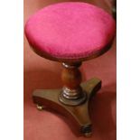 A mid-Victorian mahogany upholstery topped revolving piano stool,