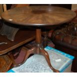 A 19th century radial veneered flame mahogany circular tilt-top tripod table,