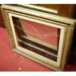 A late 19th century floral giltwood decorated rectangular picture frame,