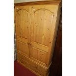 A modern pine double door wardrobe, having four short lower drawers, w.