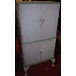 A painted four door drinks cabinet having mirrored pull-out slide