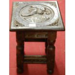 A Continental antique joined oak square section joint stool, low relief carved with bust portrait,