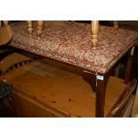 A mahogany and red floral upholstered and studded twin footstool,