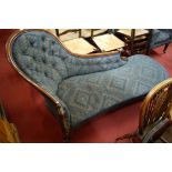 A mid-Victorian mahogany framed and geometric buttonback upholstered spoonback chaise-longue