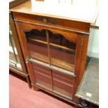 A 1930s oak single door glazed bookcase