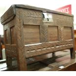 An antique joined and line carved oak hinge-top three panelled coffer, of small proportions, w.