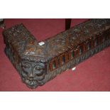 A circa 1900 low relief carved oak firekerb, of good size, having Green Man masked canted corners,