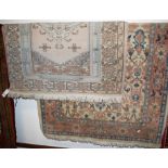Two Persian style machine woven woollen cream ground rugs